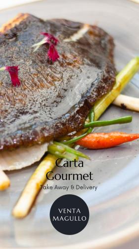 a plate of food with meat and vegetables on it at Hotel Venta Magullo in La Lastrilla
