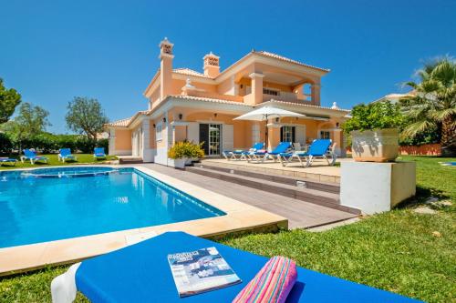 a villa with a swimming pool and a house at Villa Savannah by Algarve Vacation in Almancil