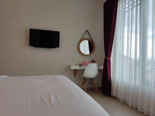 Ένα ή περισσότερα κρεβάτια σε δωμάτιο στο Alana House Syariah