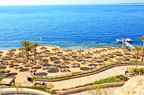 an aerial view of a beach with umbrellas and the ocean at Reef Oasis Blue Bay Resort & Spa in Sharm El Sheikh