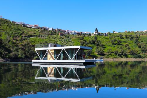 a boat is docked on the water on a lake at Floating Álvaro in Alvaro