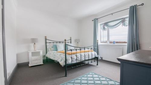 a bedroom with a bed and a window at Cosy cottage near Saltburn & Whitby in Boosbeck