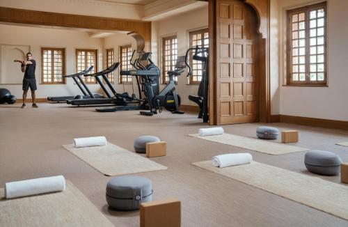 a woman standing in a gym with pilates equipment at Six Senses Fort Barwara Sawai Madhopur in Sawāi Mādhopur