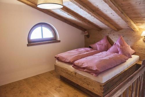 a bedroom with two beds with pink pillows at Berghotel Birkenhof GmbH in Reit im Winkl