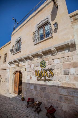 a building with a sign on the side of it at Mak's Cave House in Uchisar