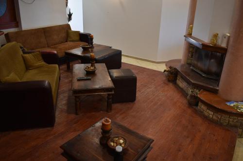 a living room with a couch and a coffee table at Ξενώνας Παρατηρητήριο Υπερώον in Ágios Athanásios