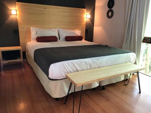 a bedroom with a large bed with a wooden headboard at Aguamansa in Las Gaviotas