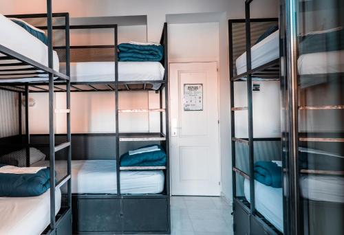 a room with four bunk beds in a dorm room at JOY Setas Coworking in Seville