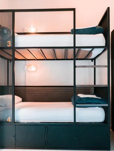 a bunk bed with four bunk beds in a room at JOY Setas Coworking in Seville