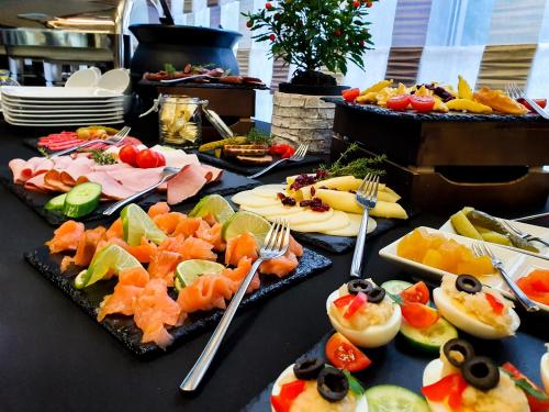 a table topped with lots of different types of food at Rysy Boutique Hotel in Zakopane