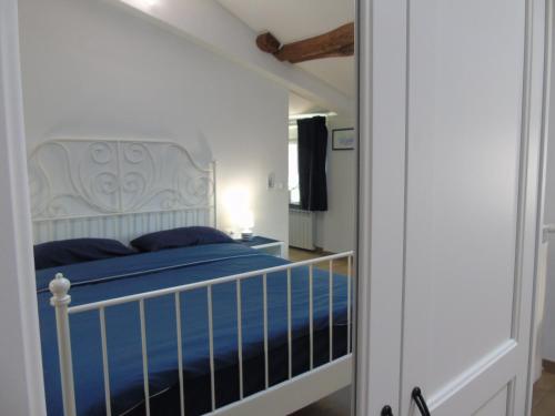 a bedroom with a bed with a white headboard at IL PERGOLATO con parcheggio privato in Genoa