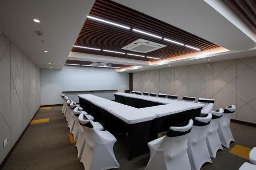 a conference room with a long table and chairs at IKON By Annapoorna in Coimbatore