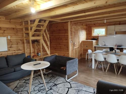 a living room with a couch and a table at Wiejska Sielanka noclegi Ustroń in Ustroń