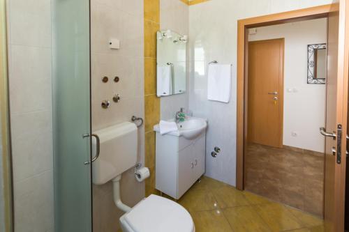 a bathroom with a toilet and a sink at Apartments Veronika in Pag