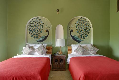 Cama o camas de una habitación en Maya Garh Pushkar