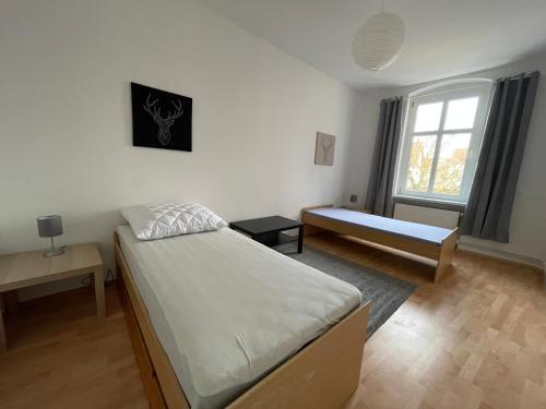 1 dormitorio con 2 camas y ventana en Tränental 4.2 en Staßfurt