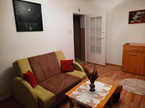 a living room with a couch and a coffee table at Mieszkanie M3 in Szczytno