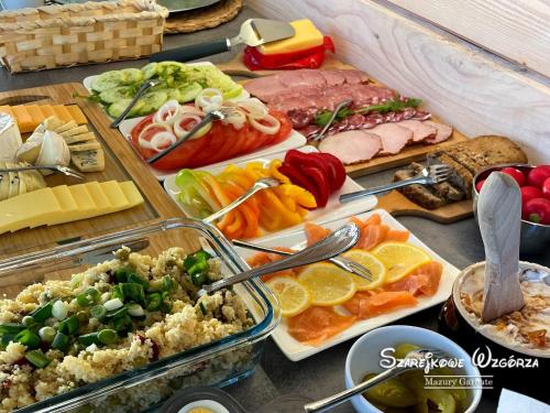 a table topped with lots of different types of food at Szarejkowe Wzgórza in Szarejki