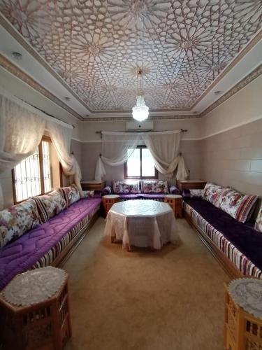 a large living room with couches and a table at Dar LALA NEJMA in Marrakesh