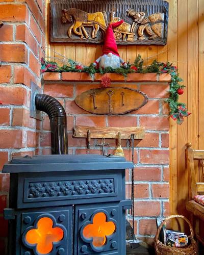 a blue stove with orange flowers on a brick wall at M&M Kuća za odmor in Vrbovec