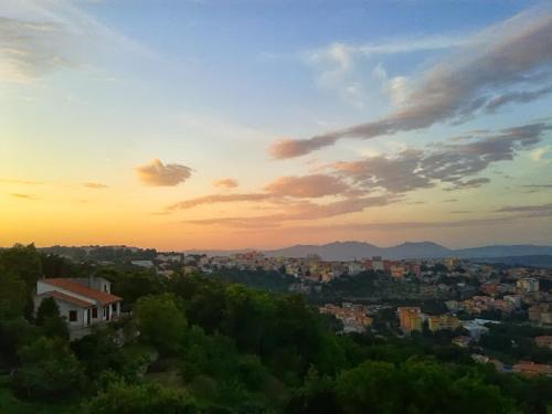 a view of a city with the sunset in the background at B&B Meladormo in Tempio Pausania