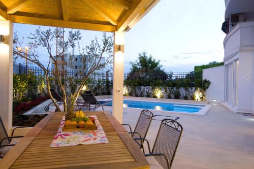 a patio with a table and chairs and a pool at Luxury Apartment Split in Split