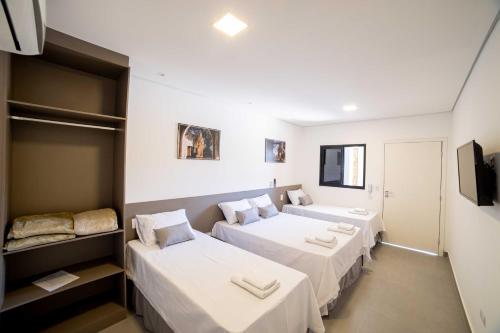 A bed or beds in a room at Cadiz Pousada e Lazer