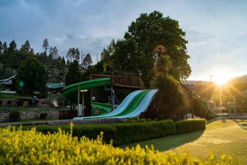 a green slide at a park with the sun setting at Gooderson Drakensberg Gardens Golf & Spa Resort in Drakensberg Garden