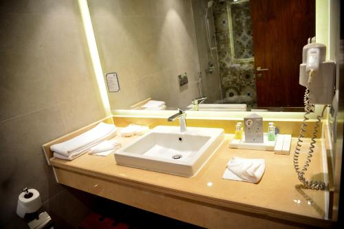 a bathroom counter with a sink and a mirror at Marina Sharm Hotel in Sharm El Sheikh