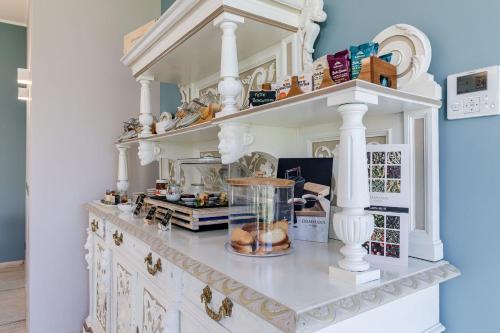 a kitchen with white columns and a counter with a bowl on it at L'aja della Mirusina - Piedmont Resort Monferrato Langhe in Canelli