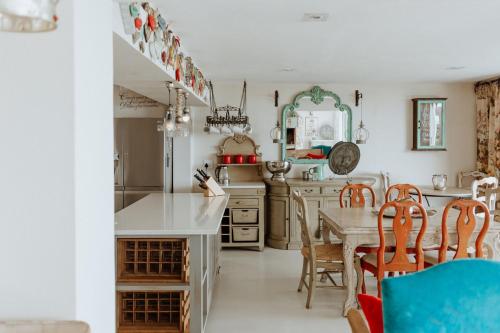 a kitchen with a table and a dining room at Nosterdomus in Paternoster