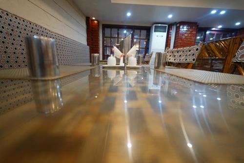 a lobby with a table and chairs in a building at Hotel Palmyra Grand Inn in Tirunelveli