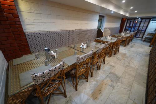an overhead view of a restaurant with tables and chairs at Hotel Palmyra Grand Inn in Tirunelveli