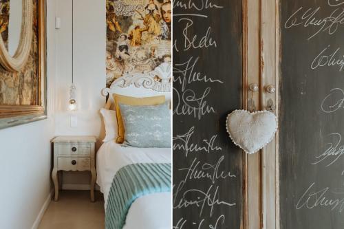 a bedroom with a chalkboard wall with writing on it at Nosterdomus in Paternoster