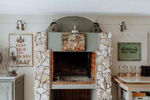 a living room with a stone fireplace at Nosterdomus in Paternoster