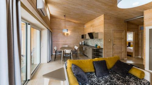 a living room and kitchen with a couch and a table at Stranda in Giżycko