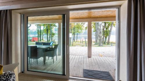 a sliding glass door leading to a patio with a table at Stranda in Giżycko