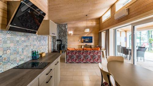 a kitchen and living room with a table and chairs at Stranda in Giżycko