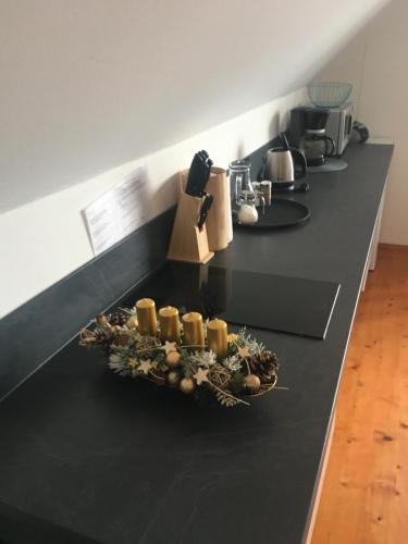 a black counter top with candles on it at Tatraview House in Veľká Lomnica