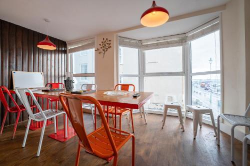 a dining room with a wooden table and chairs at Sealanes 1 in Brighton & Hove