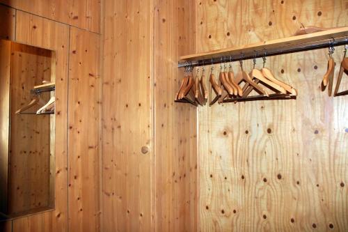 a room with wooden walls and wooden racks with wooden shoes at Hotel Gasthof Zum weissen Lamm in Hohenberg an der Eger