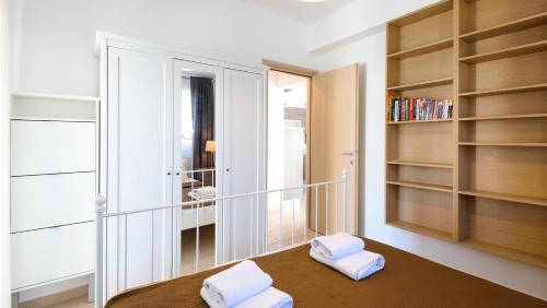 a room with a table with two white pillows on it at Botanica Villas & Apartments in Neos Marmaras