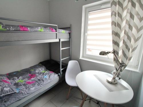 a small room with a desk and bunk beds at Marina Santok in Santok