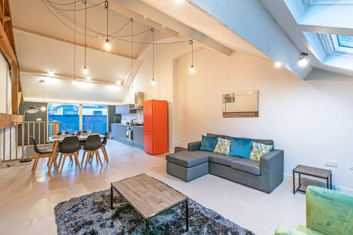 a living room with a couch and a table at Carriage Works by Guestz in Preston