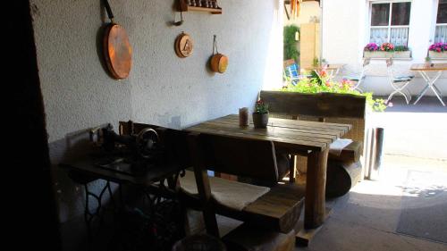 a kitchen with a wooden table and a table and a sink at Hotel Gasthof Zum weissen Lamm in Hohenberg an der Eger