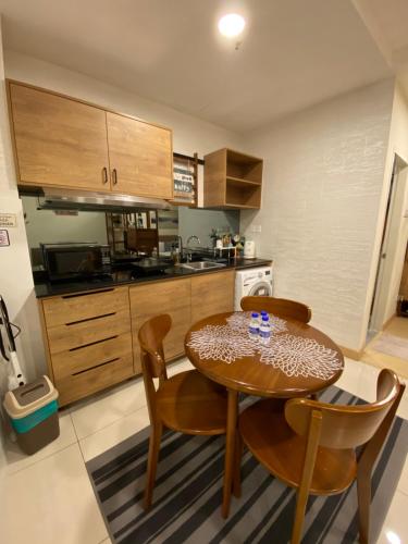 a kitchen with a table and chairs in a room at The Jomvacay Place in Kuantan