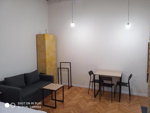 a living room with a couch and a table and chairs at Gogol 14 Апартаменти в історичному центрі міста in Uzhhorod