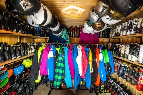 a shelf filled with different colored shirts and helmets at Skyta in Vorokhta