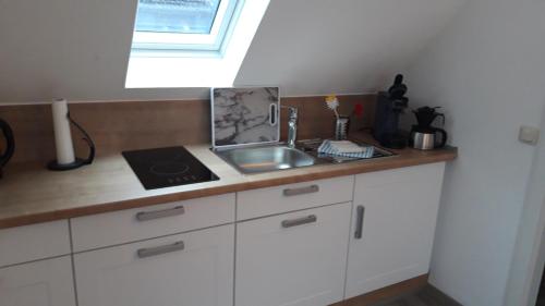 a kitchen counter with a sink and a window at Ferienwohnung an der Kurklinik in Bad Driburg