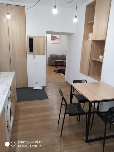 a kitchen and living room with a table and chairs at Gogol 14 Апартаменти в історичному центрі міста in Uzhhorod